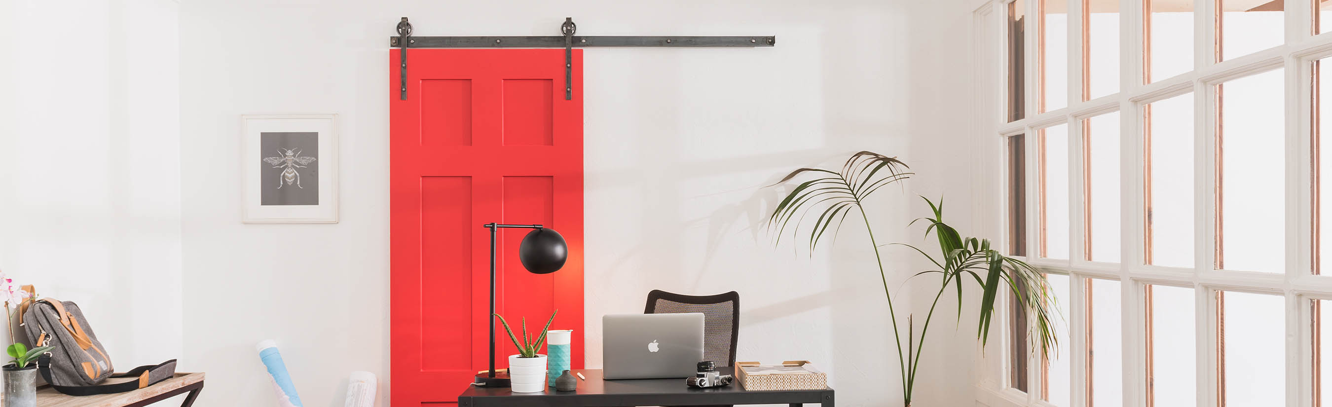 Bright red barn door in a white and modern office.